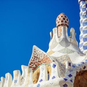 Ornate mosaic rooftop with colorful, geometric patterns against a bright blue sky.